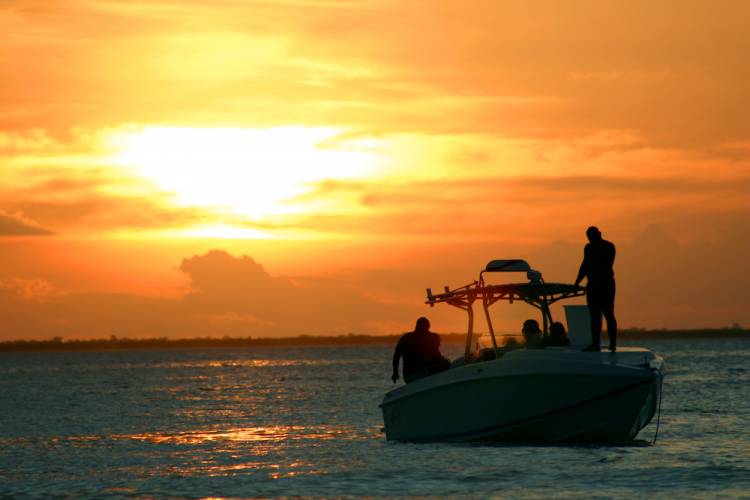 people on a boat at sunset